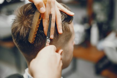 A man in a barbershop. A man cuts hair in a barbershop. Rest in hairdressing salon